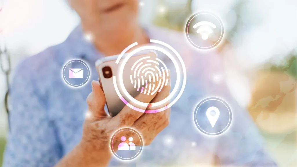Stock photo of an older person holding a smartphone with a glowing fingerprint icon and app symbols overlaid